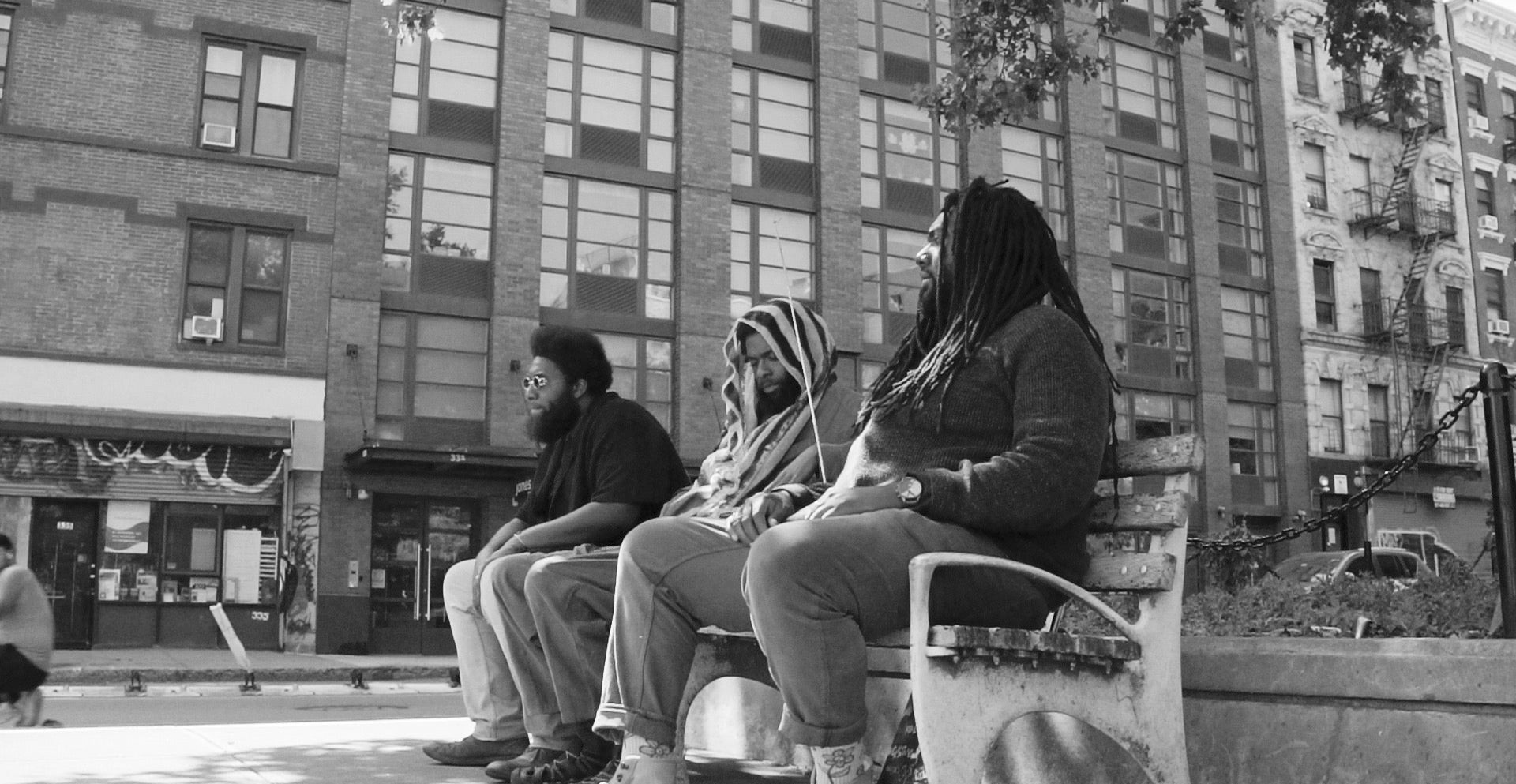 Band photo sitting on bench in DC